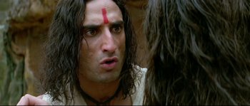 Movie still from “Asoka” (2001), directed by Santosh Sivan – A person with long black hair; Close Up shot, Low angle
