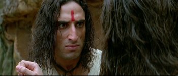 Movie still from “Asoka” (2001), directed by Santosh Sivan – A person with long black hair; Close Up shot, Low angle