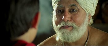 Movie still from “Asoka” (2001), directed by Santosh Sivan – An old man with a white beard is looking at a woman; Close Up shot, Low angle
