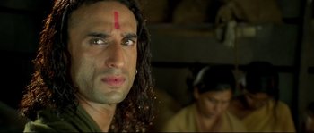 Movie still from “Asoka” (2001), directed by Santosh Sivan – A person with long black hair; Close Up shot, Low angle