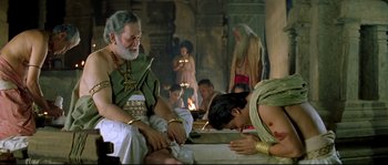 Movie still from “Asoka” (2001), directed by Santosh Sivan – An old man and a young man in ancient roman garb; Medium shot, High angle