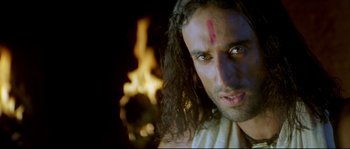 Movie still from “Asoka” (2001), directed by Santosh Sivan – A person with long dark hair; Close Up shot, High angle