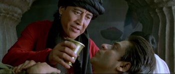 Movie still from “Asoka” (2001), directed by Santosh Sivan – A woman holding onto a cup while a man looks at her face; Close Up shot, Low angle