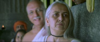 Movie still from “Asoka” (2001), directed by Santosh Sivan – An older woman and a younger man looking at the camera; Close Up shot, Low angle