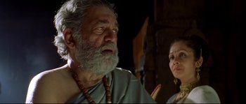 Movie still from “Asoka” (2001), directed by Santosh Sivan – An older man and a younger woman are looking at each other; Close Up shot, Low angle