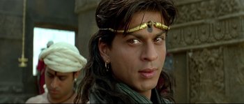 Movie still from “Asoka” (2001), directed by Santosh Sivan – A person wearing a headband; Close Up shot, Over the shoulder angle