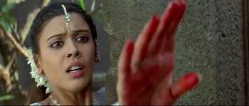 Movie still from “Asoka” (2001), directed by Santosh Sivan – A person with their hands in the air; Close Up shot, Overhead angle
