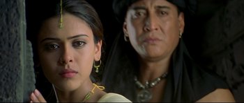 Movie still from “Asoka” (2001), directed by Santosh Sivan – A man and a woman are standing next to each other; Close Up shot, Low angle