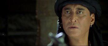Movie still from “Asoka” (2001), directed by Santosh Sivan – A person with a gun; Close Up shot, Low angle