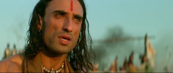 Movie still from “Asoka” (2001), directed by Santosh Sivan – A person with long black hair; Close Up shot, Low angle