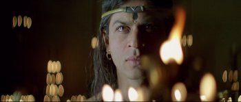 Movie still from “Asoka” (2001), directed by Santosh Sivan – A person wearing a headband; Close Up shot, High angle