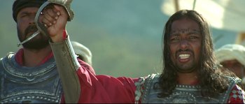 Movie still from “Asoka” (2001), directed by Santosh Sivan – A man and a woman are standing next to each other; Close Up shot, Low angle