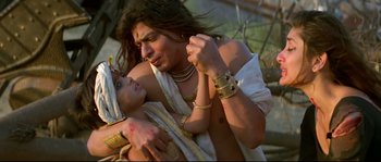 Movie still from “Asoka” (2001), directed by Santosh Sivan – A man and a woman are holding each other; Close Up shot, High angle