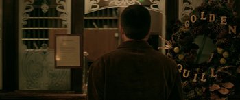 Movie still from “Bad Words” (2013), directed by Jason Bateman – A man standing in front of a mirror in a room; Medium shot, Over the shoulder angle