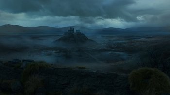 Movie still from “Game of Thrones” (2011), created by D.B. Weiss – A castle on top of a hill in the middle of a valley; Extreme Wide shot, High angle
