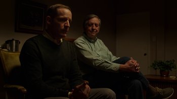 Movie still from “Better Call Saul” (2015), created by Vince Gilligan – Two men sitting on a couch in a room; Medium shot, Low angle