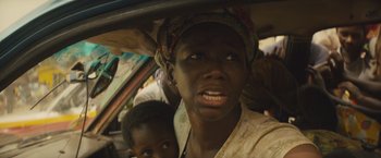 Movie still from “Beasts of No Nation” (2015), directed by Cary Joji Fukunaga – A woman and a child in the back of a car; Close Up shot, High angle