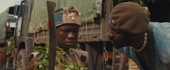 Movie still from “Beasts of No Nation” (2015), directed by Cary Joji Fukunaga – A man and a woman are standing next to each other; Close Up shot, Over the shoulder angle
