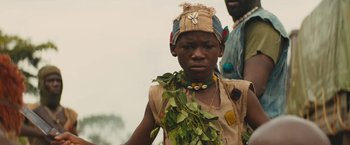 Movie still from “Beasts of No Nation” (2015), directed by Cary Joji Fukunaga – A young boy wearing a hat and a necklace; Close Up shot, Low angle