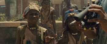 Movie still from “Beasts of No Nation” (2015), directed by Cary Joji Fukunaga – A group of people standing next to each other; Close Up shot, Low angle