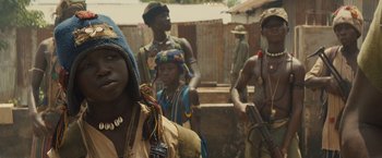 Movie still from “Beasts of No Nation” (2015), directed by Cary Joji Fukunaga – A group of people standing next to each other; Close Up shot, Over the shoulder angle