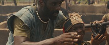 Movie still from “Beasts of No Nation” (2015), directed by Cary Joji Fukunaga – A man and a woman sitting on the ground; Close Up shot, High angle