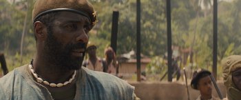 Movie still from “Beasts of No Nation” (2015), directed by Cary Joji Fukunaga – A group of people standing next to each other on a field; Close Up shot, Over the shoulder angle