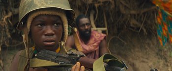 Movie still from “Beasts of No Nation” (2015), directed by Cary Joji Fukunaga – A man and a boy in a jungle with a rifle; Close Up shot, Over the shoulder angle