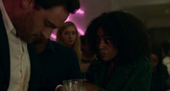 Movie still from “Behind Her Eyes” (2021), directed by Erik Richter Strand – A woman is sitting at a table with a glass of wine; Close Up shot, Over the shoulder angle