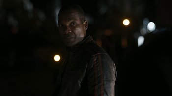 Movie still from “Better Call Saul” (2015), created by Vince Gilligan – A man wearing a leather jacket standing in the dark; Close Up shot, Over the shoulder angle