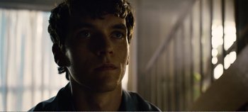 Movie still from “Black Mirror: Bandersnatch” (2018), directed by David Slade – A person looking at the camera; Close Up shot, Low angle