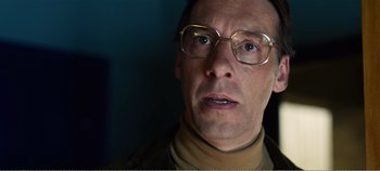Movie still from “Black Mirror: Bandersnatch” (2018), directed by David Slade – A person wearing glasses; Close Up shot, Low angle