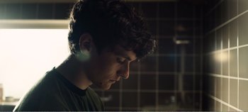 Movie still from “Black Mirror: Bandersnatch” (2018), directed by David Slade – A young man is looking down at his face; Close Up shot, Low angle