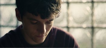 Movie still from “Black Mirror: Bandersnatch” (2018), directed by David Slade – A person with his eyes closed; Close Up shot, Low angle