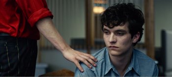 Movie still from “Black Mirror: Bandersnatch” (2018), directed by David Slade – A person touching the shoulder of another person; Close Up shot, Over the shoulder angle