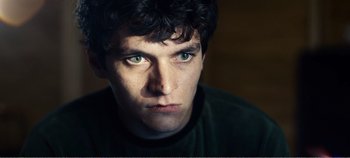 Movie still from “Black Mirror: Bandersnatch” (2018), directed by David Slade – A person with green eyes; Close Up shot, High angle