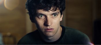 Movie still from “Black Mirror: Bandersnatch” (2018), directed by David Slade – A man's face with green eyes; Close Up shot, Overhead angle