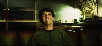 Movie still from “Black Mirror: Bandersnatch” (2018), directed by David Slade – A man sitting in a chair with his mouth wide open; Close Up shot, Low angle