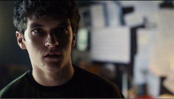 Movie still from “Black Mirror: Bandersnatch” (2018), directed by David Slade – A young man is looking into the camera; Close Up shot, Low angle