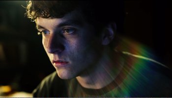 Movie still from “Black Mirror: Bandersnatch” (2018), directed by David Slade – A young man is looking into the light; Close Up shot, Low angle