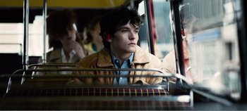 Movie still from “Black Mirror: Bandersnatch” (2018), directed by David Slade – A young man sitting on a bus looking out of the window; Close Up shot, Over the shoulder angle
