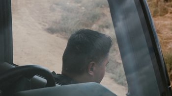Movie still from “Better Call Saul” (2015), created by Vince Gilligan – A young man is sitting in the back of a vehicle; Close Up shot, High angle