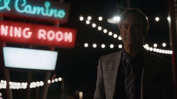 Movie still from “Better Call Saul” (2015), created by Vince Gilligan – A man standing in front of a neon sign at night; Close Up shot, Low angle