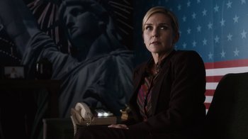 Movie still from “Better Call Saul” (2015), created by Vince Gilligan – A woman sitting in front of a statue of liberty; Medium shot, Low angle