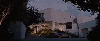 Movie still from “Bridesmaids” (2011), directed by Paul Feig – A car parked in front of a white building; Extreme Wide shot, Low angle