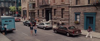 Movie still from “Bridesmaids” (2011), directed by Paul Feig – A group of people walking down a street near parked cars; Extreme Wide shot, High angle