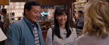 Movie still from “Bridesmaids” (2011), directed by Paul Feig – A man and a woman standing next to each other; Medium shot, Over the shoulder angle