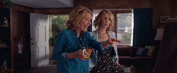 Movie still from “Bridesmaids” (2011), directed by Paul Feig – Two women standing next to each other in a living room; Medium shot, Over the shoulder angle