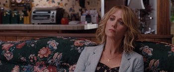 Movie still from “Bridesmaids” (2011), directed by Paul Feig – A woman sitting on a couch in front of a mirror; Close Up shot, Over the shoulder angle