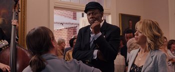 Movie still from “Bridesmaids” (2011), directed by Paul Feig – An older man wearing a hat and a suit; Medium shot, Over the shoulder angle